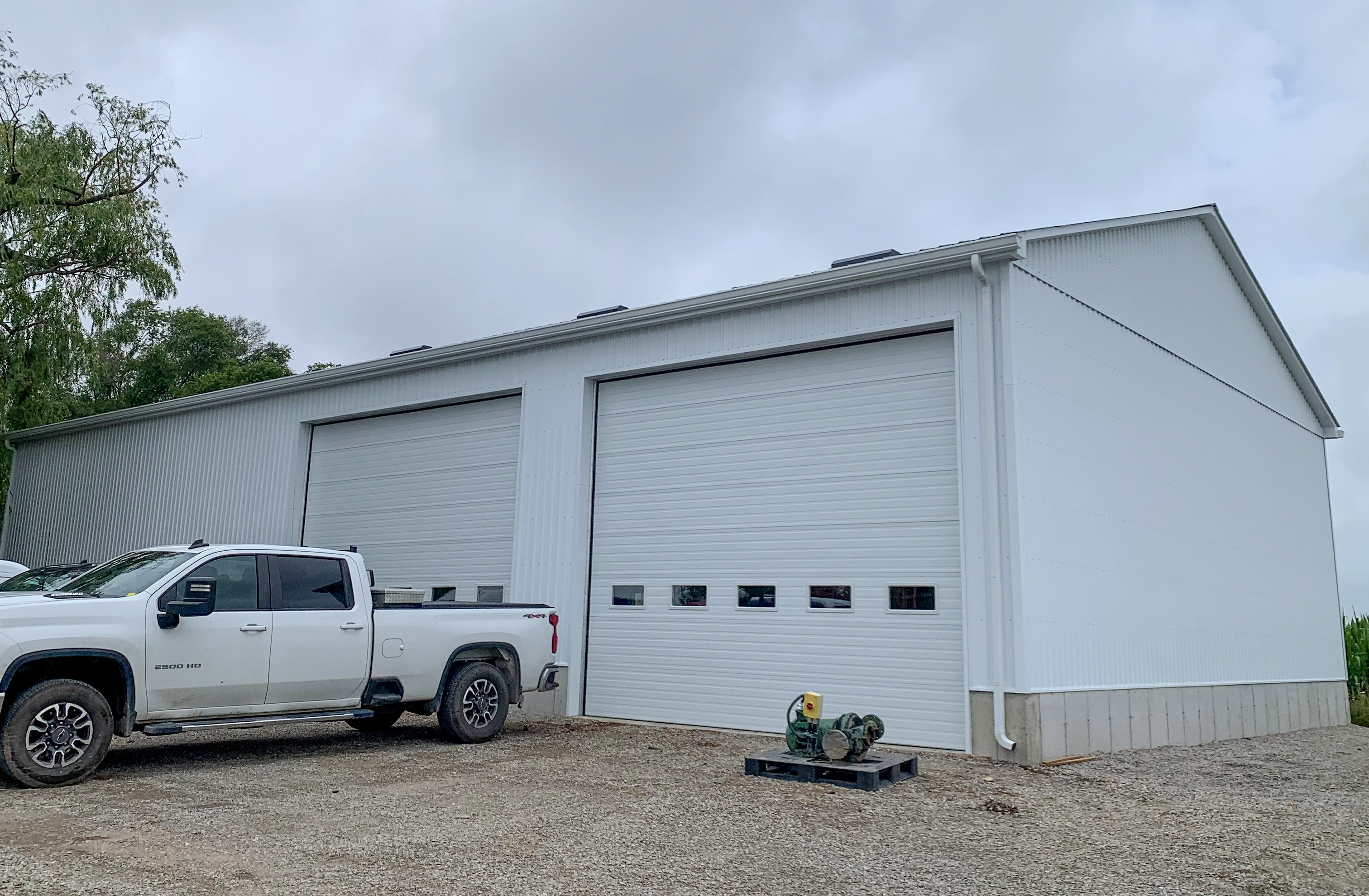 White steel shop with two overhead doors