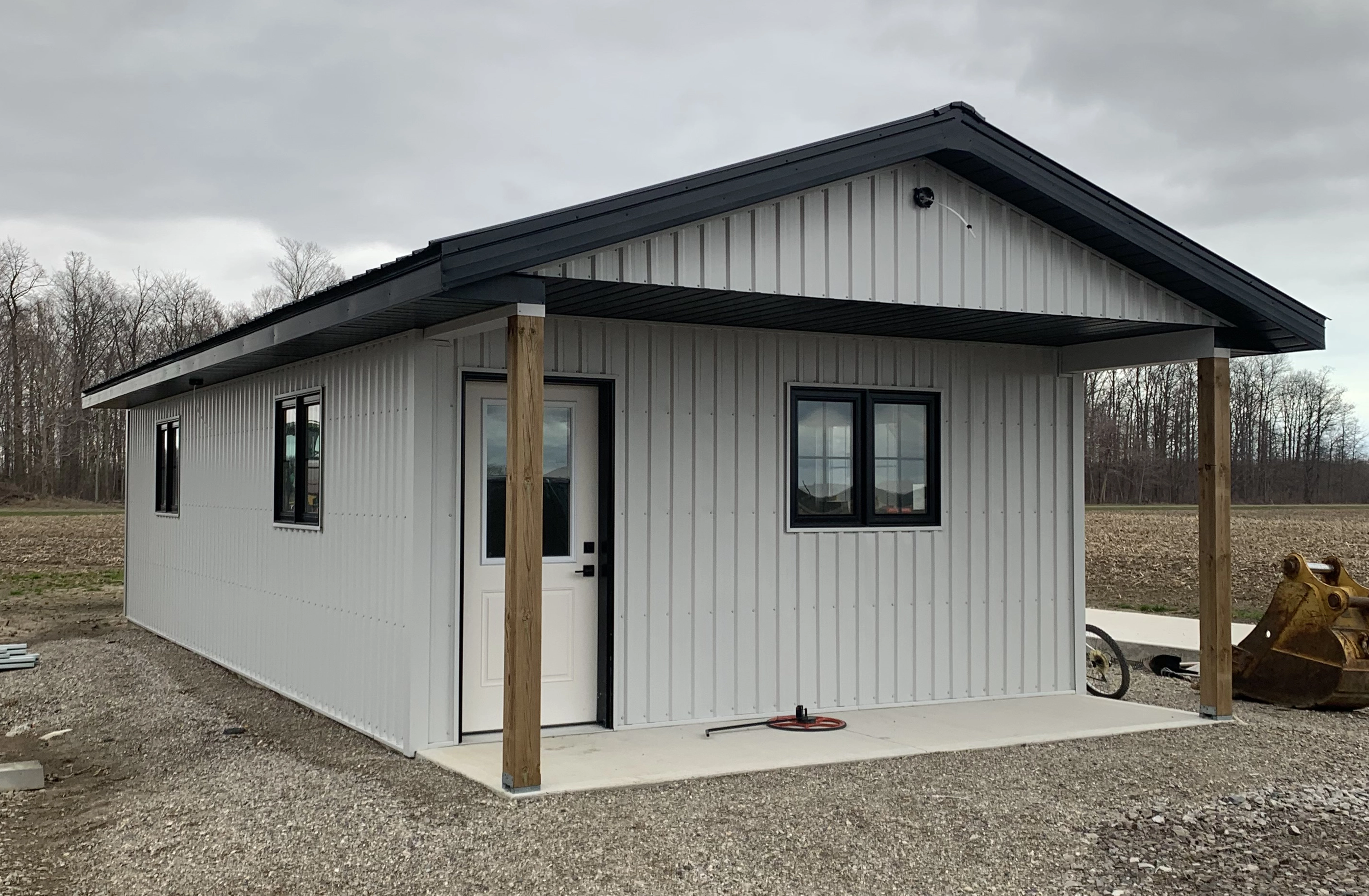 White steel cabin with covered porch